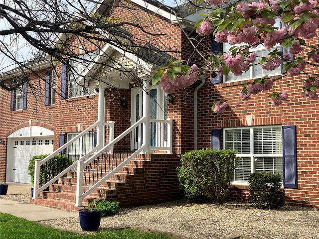 exterior space featuring brick siding and a garage