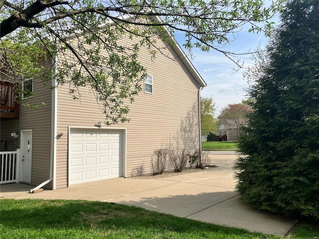 view of home's exterior featuring concrete driveway and an attached garage