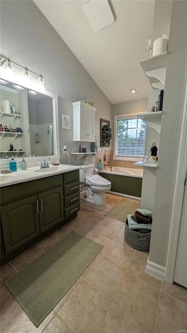 bathroom with a garden tub, tile patterned flooring, vanity, toilet, and vaulted ceiling