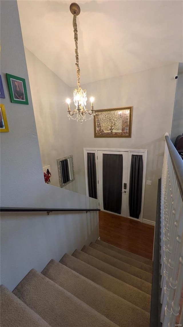 stairs featuring an inviting chandelier