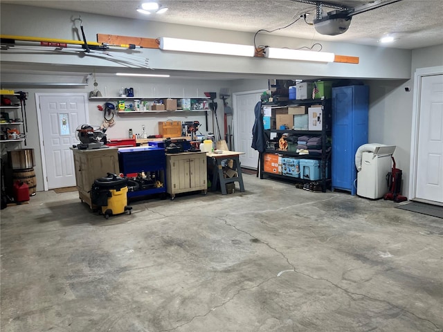 garage featuring a garage door opener and a workshop area