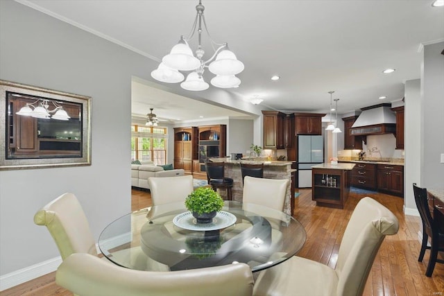 dining space with recessed lighting, baseboards, ornamental molding, and hardwood / wood-style flooring