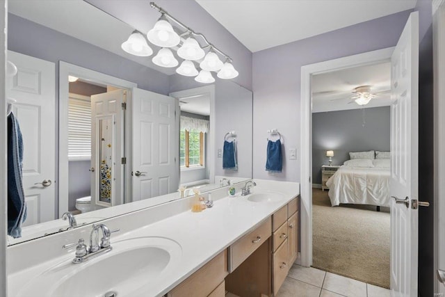 ensuite bathroom with tile patterned flooring, a sink, connected bathroom, and toilet