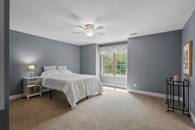 bedroom with carpet floors, baseboards, and a ceiling fan