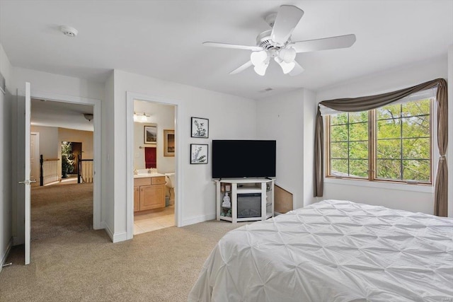 bedroom with light colored carpet, a ceiling fan, and baseboards