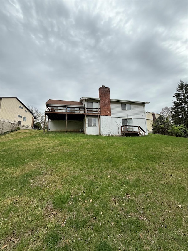 back of house featuring a yard and a chimney