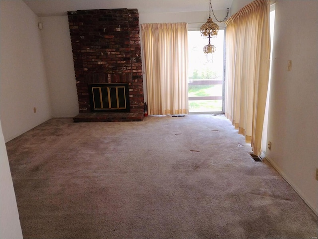 unfurnished living room featuring visible vents, carpet flooring, and a fireplace