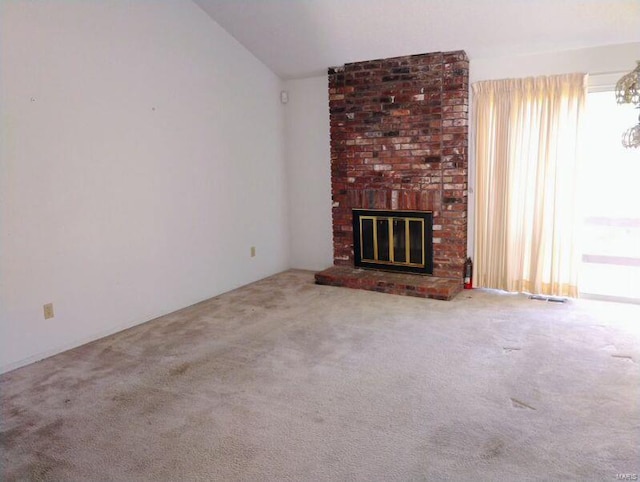 unfurnished living room with lofted ceiling, a brick fireplace, visible vents, and carpet