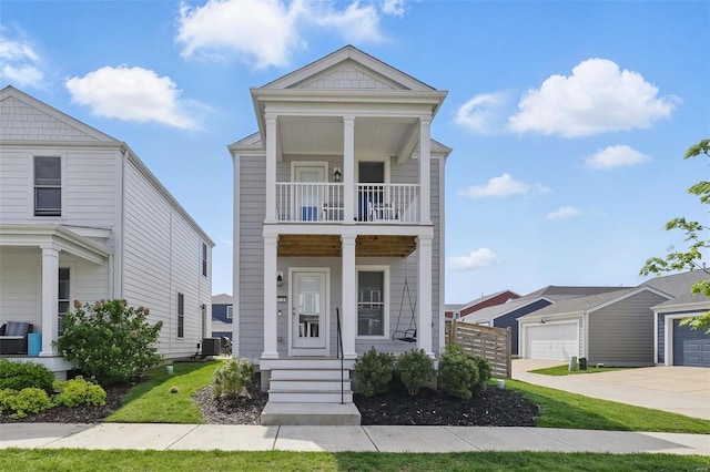 view of front of home with a porch, driveway, a garage, central air condition unit, and a balcony