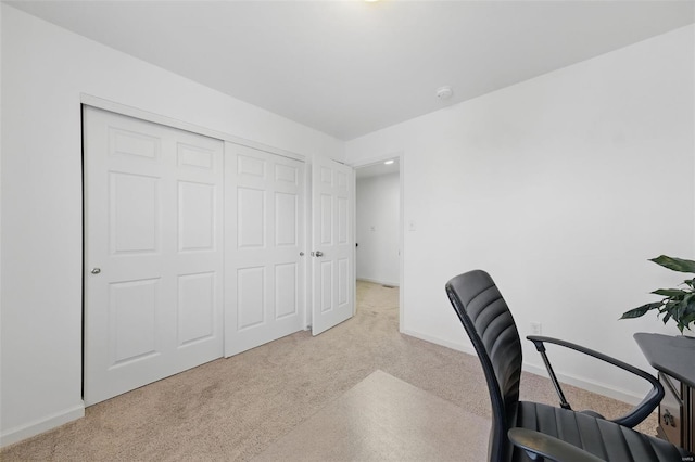 carpeted home office with baseboards