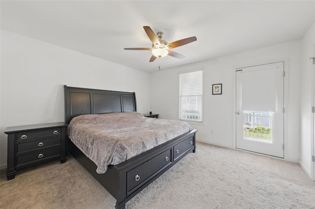 bedroom featuring a ceiling fan, baseboards, and light carpet