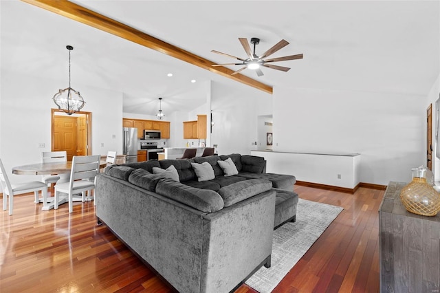 living room featuring a ceiling fan, a chandelier, wood-type flooring, and baseboards