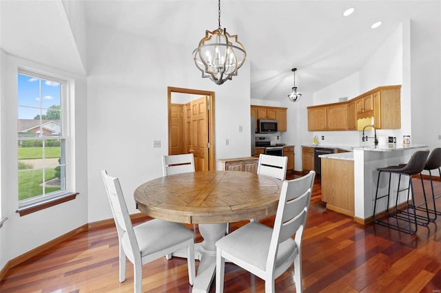 dining room with high vaulted ceiling, a chandelier, light wood-style floors, recessed lighting, and baseboards