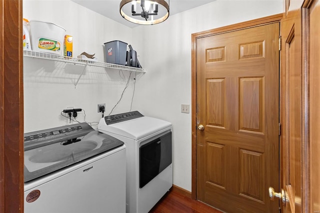 clothes washing area featuring separate washer and dryer, a chandelier, and dark wood-style flooring