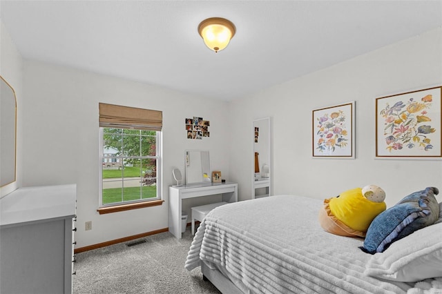 bedroom with light carpet and baseboards