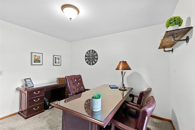 carpeted home office featuring baseboards