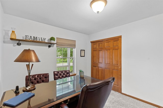 carpeted home office with baseboards