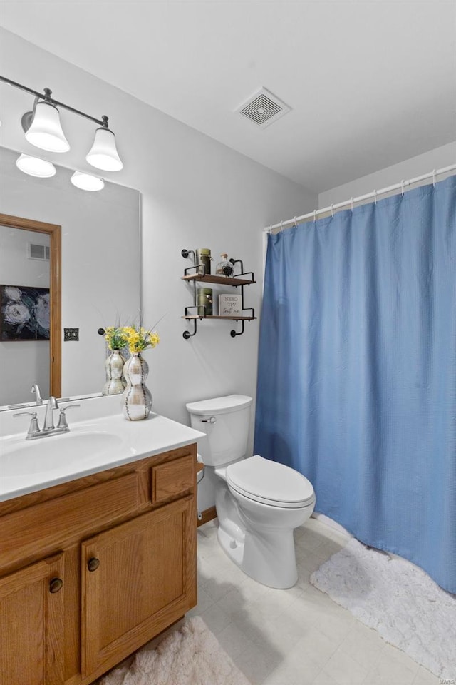 bathroom with toilet, vanity, and a shower with shower curtain