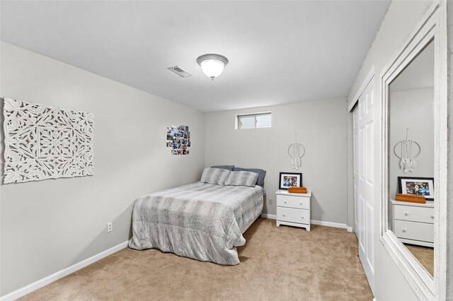 bedroom with carpet flooring, baseboards, and a closet
