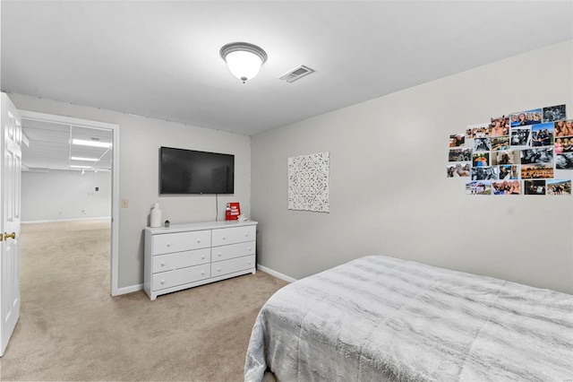 bedroom featuring light colored carpet and baseboards