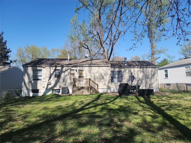 back of property with fence and a yard