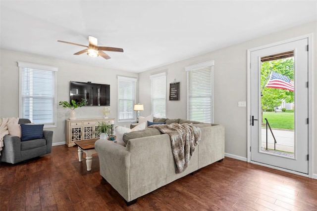 living room featuring ceiling fan, dark wood finished floors, and baseboards