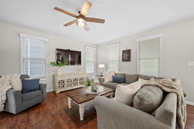 living area featuring baseboards, ceiling fan, and wood finished floors