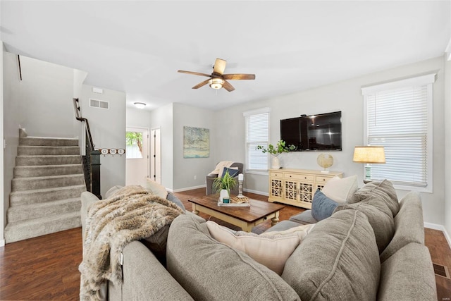 living room featuring a wealth of natural light, ceiling fan, dark wood-style flooring, and visible vents