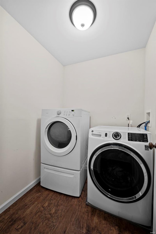 laundry area featuring separate washer and dryer, baseboards, laundry area, and dark wood-style floors