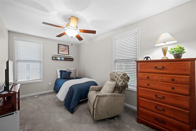 carpeted bedroom with baseboards and ceiling fan
