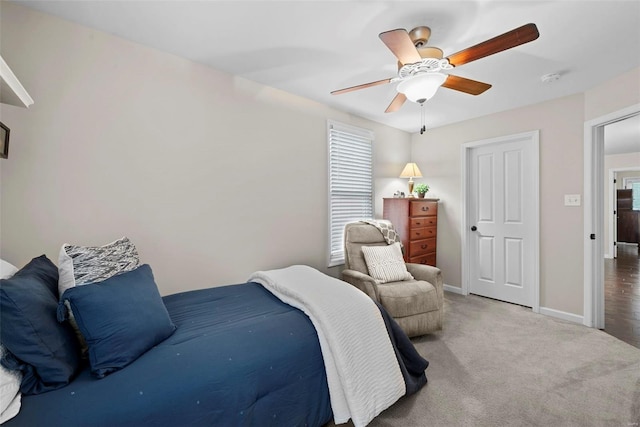bedroom featuring baseboards, ceiling fan, and carpet