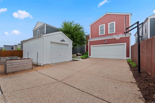 detached garage featuring fence