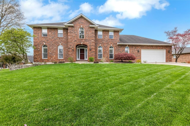 colonial inspired home with roof with shingles, an attached garage, a front lawn, brick siding, and concrete driveway