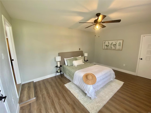 bedroom with baseboards, a ceiling fan, and wood finished floors