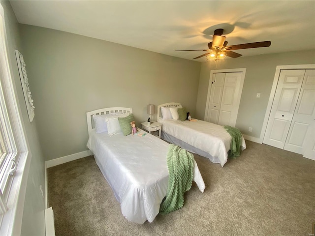 bedroom featuring carpet, multiple closets, and baseboards