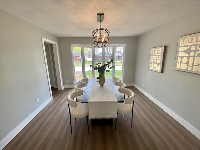 dining room featuring baseboards, a chandelier, and dark wood-type flooring