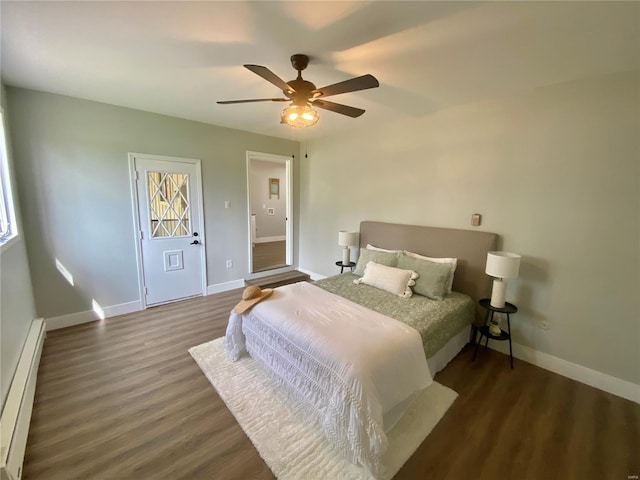 bedroom with baseboards, wood finished floors, a baseboard radiator, and ceiling fan
