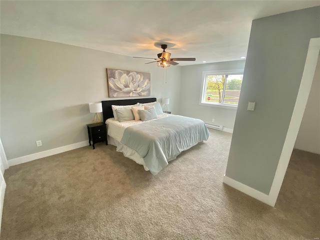 bedroom featuring a baseboard heating unit, baseboards, a ceiling fan, and carpet