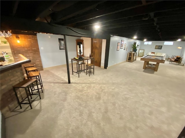 finished basement with billiards, carpet flooring, a dry bar, and brick wall
