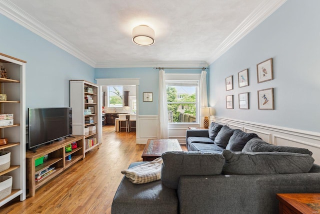 living room with wood finished floors and ornamental molding