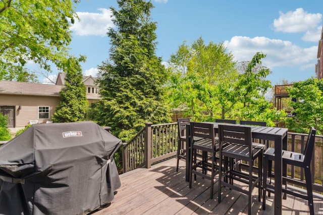 wooden deck featuring area for grilling and outdoor dining area