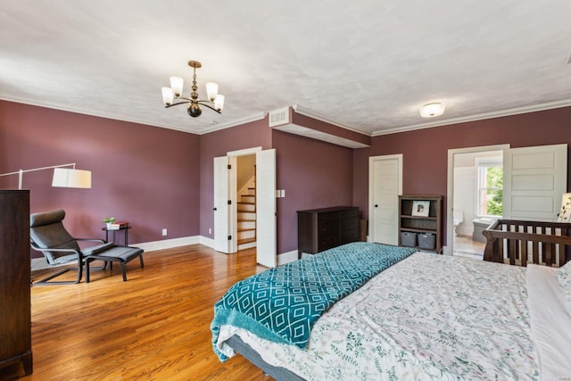 bedroom with a notable chandelier, crown molding, visible vents, baseboards, and wood finished floors