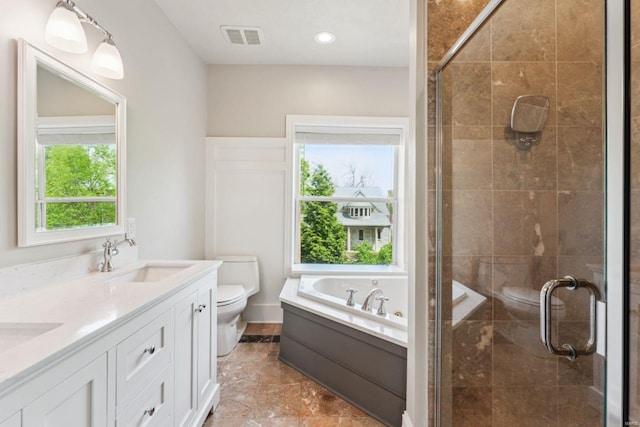 full bathroom with toilet, a sink, a shower stall, and visible vents