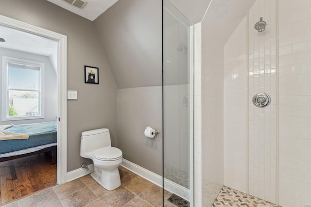 full bathroom with connected bathroom, toilet, vaulted ceiling, baseboards, and walk in shower