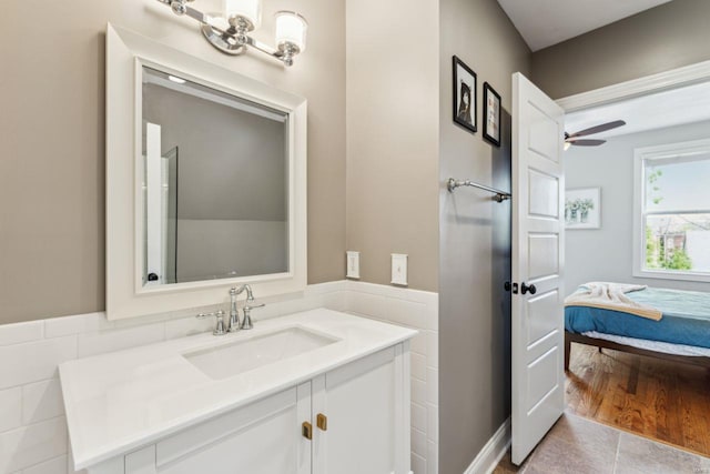 bathroom with tile patterned floors, a ceiling fan, vanity, and ensuite bathroom