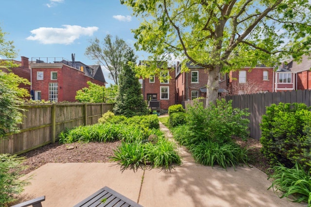 view of patio / terrace featuring fence and a residential view