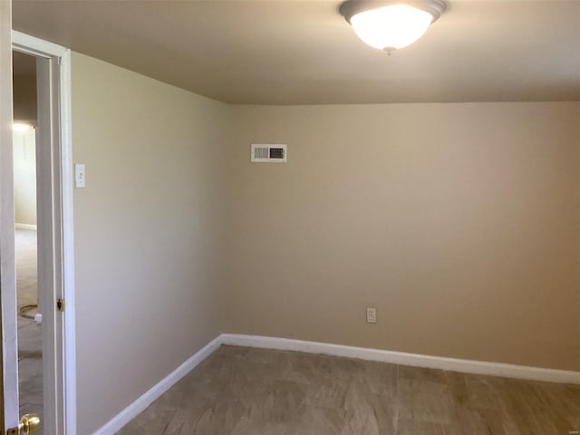 carpeted empty room with visible vents and baseboards