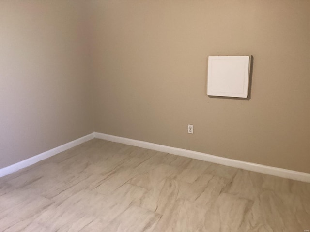 spare room featuring baseboards