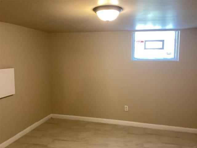 spare room with baseboards