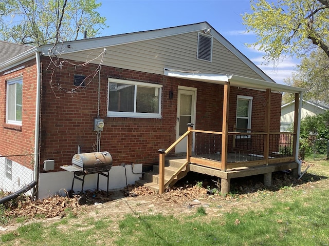 rear view of house featuring brick siding